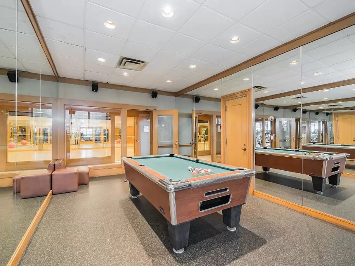 415 East 37th Street, Unit 32G Manhattan, NY 10016 - Photo 10 of 19 a room with pool table and windows