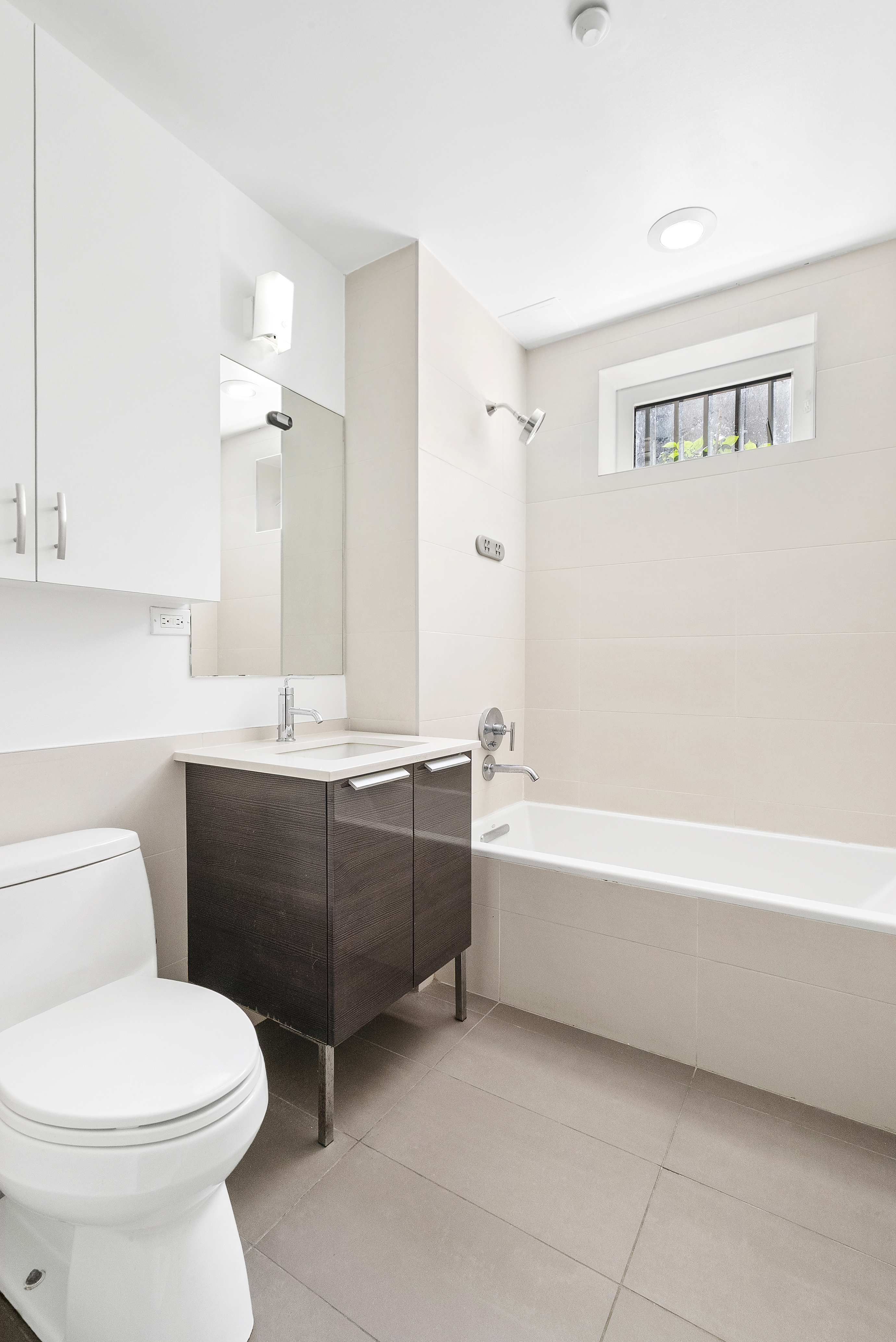 306 West 116th Street, Unit 1B Manhattan, NY 10026 - Photo 8 of 14 a bathroom with a sink a toilet and bathtub