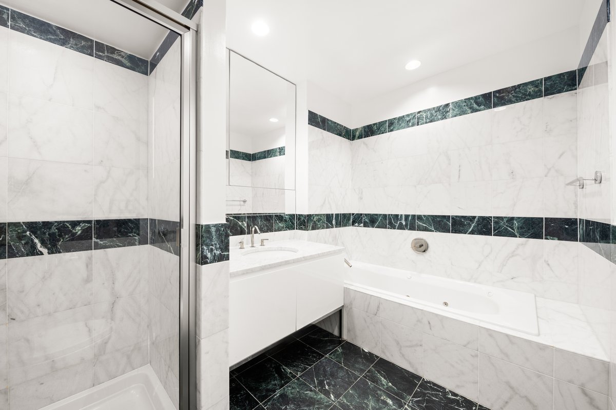 23 East 67th Street, Unit PH6 Manhattan, NY 10065 - Photo 4 of 7 a bathroom with a bathtub a shower and a mirror