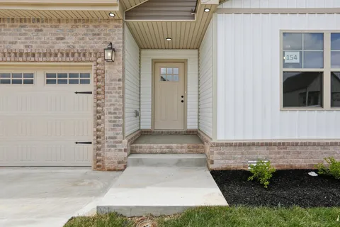 a front view of a house with a garden