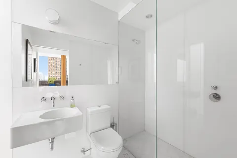 a bathroom with a sink toilet a mirror and shower