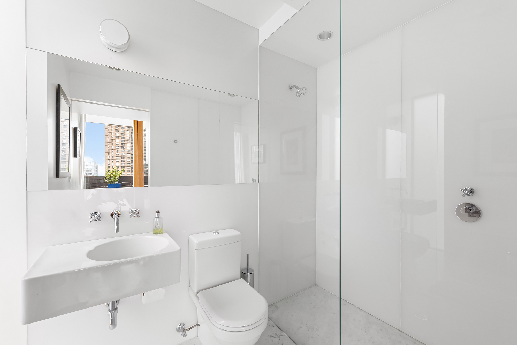 105 East 29th Street, Unit 12PH Manhattan, NY 10016 - Photo 21 of 24 a bathroom with a sink toilet a mirror and shower