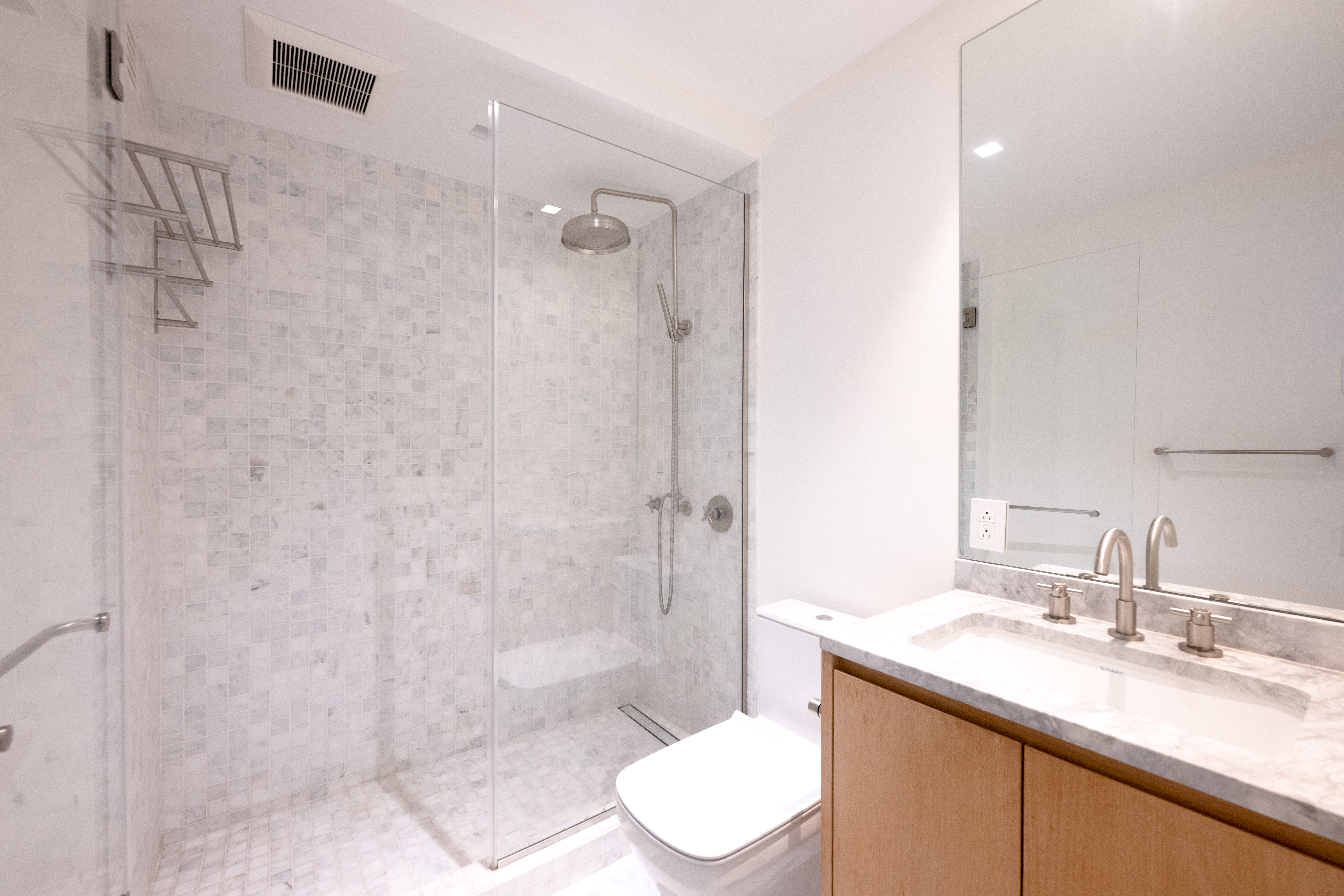 124 East 79th Street, Unit 7D Manhattan, NY 10075 - Photo 11 of 25 a bathroom with a granite countertop sink toilet and shower