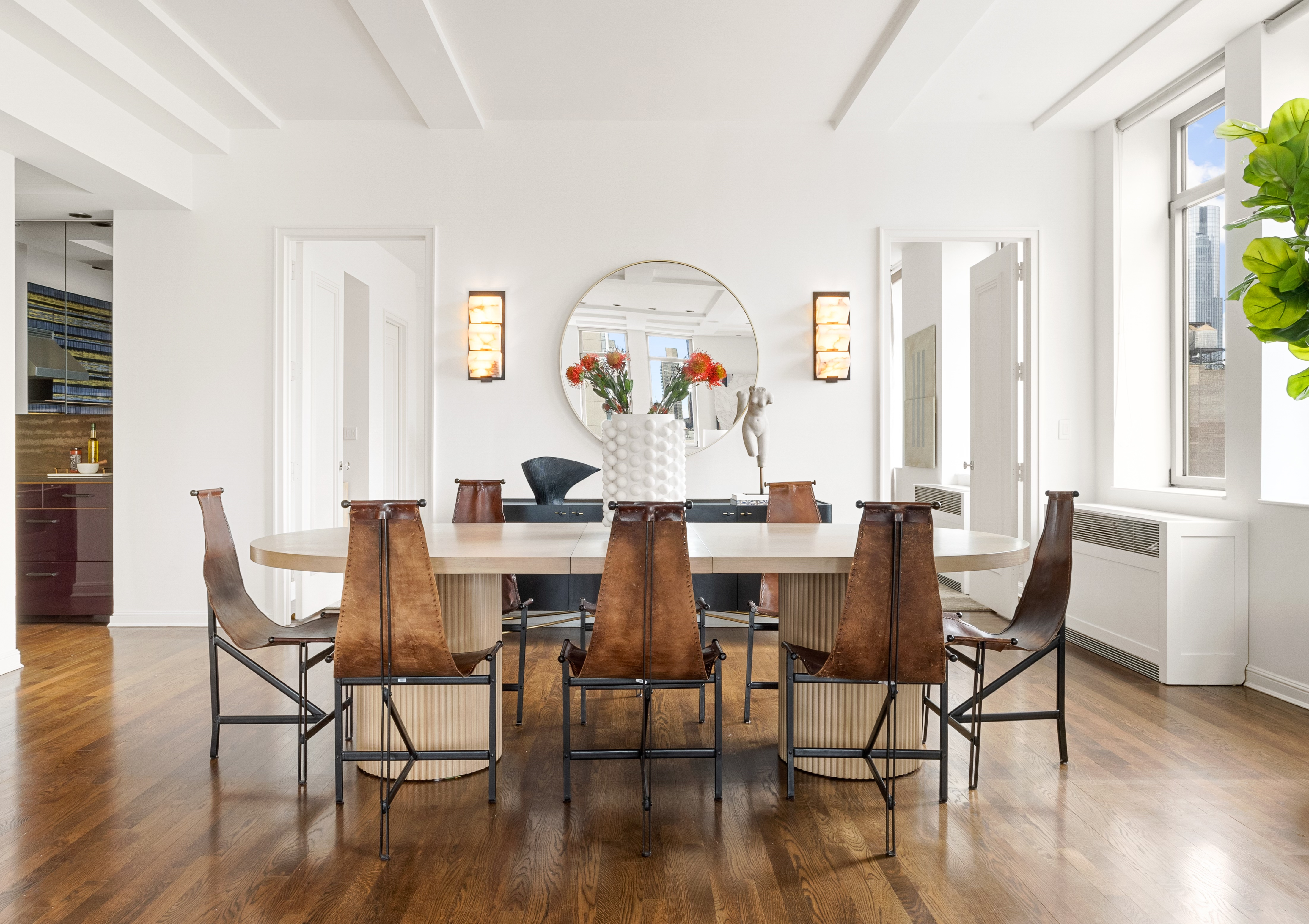 252 7th Avenue, Unit 17I Manhattan, NY 10001 - Photo 5 of 17 a view of a dining room with furniture a potted plant and wooden floor