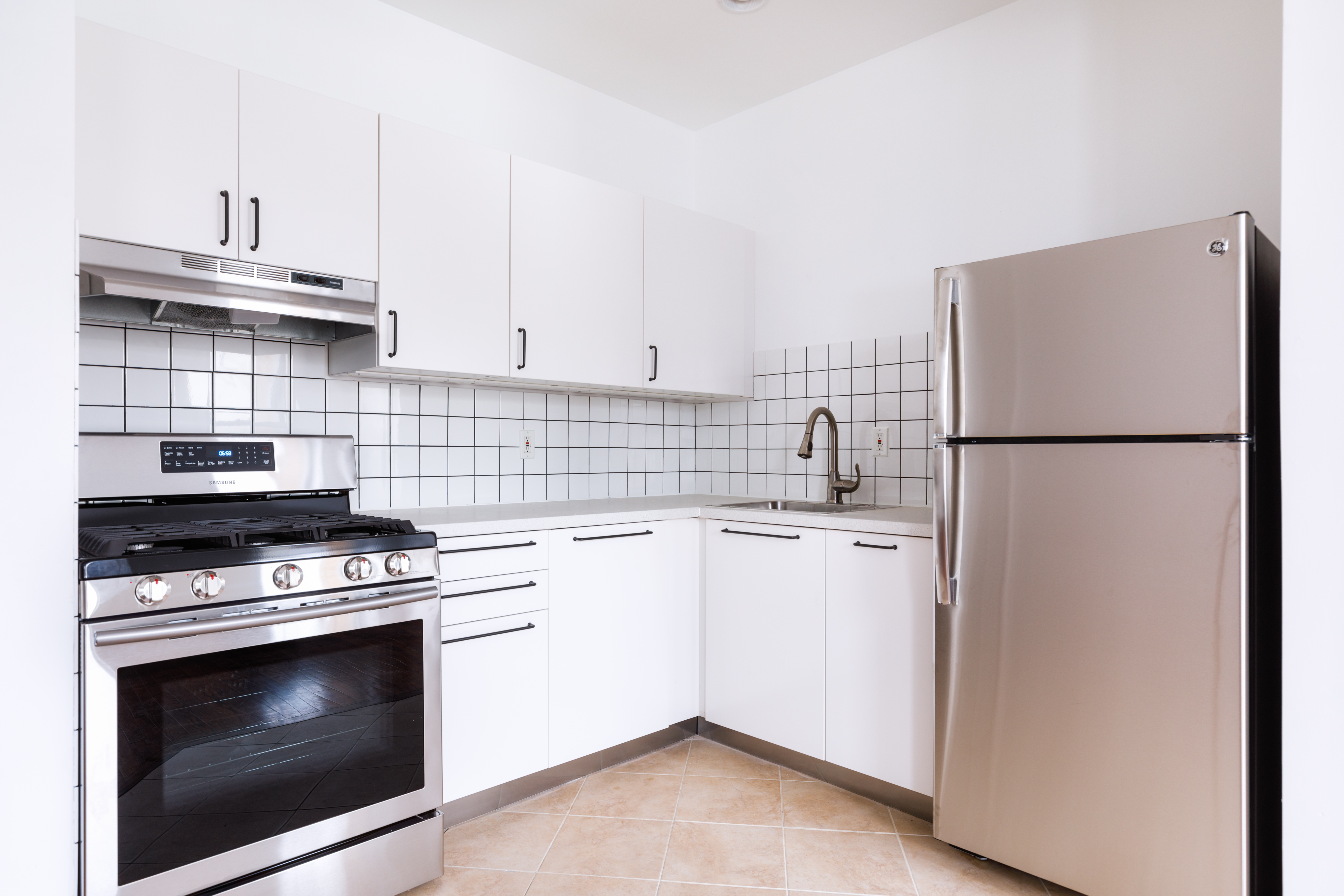 174 Patchen Avenue Brooklyn, NY 11221 - Photo 6 of 12 a kitchen with cabinets and appliances