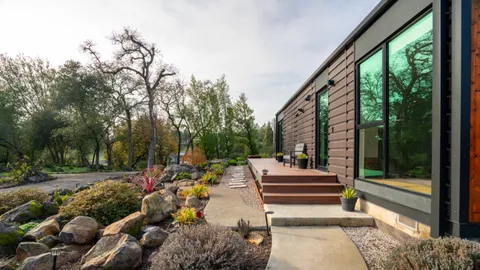 a backyard of a house with table and chairs