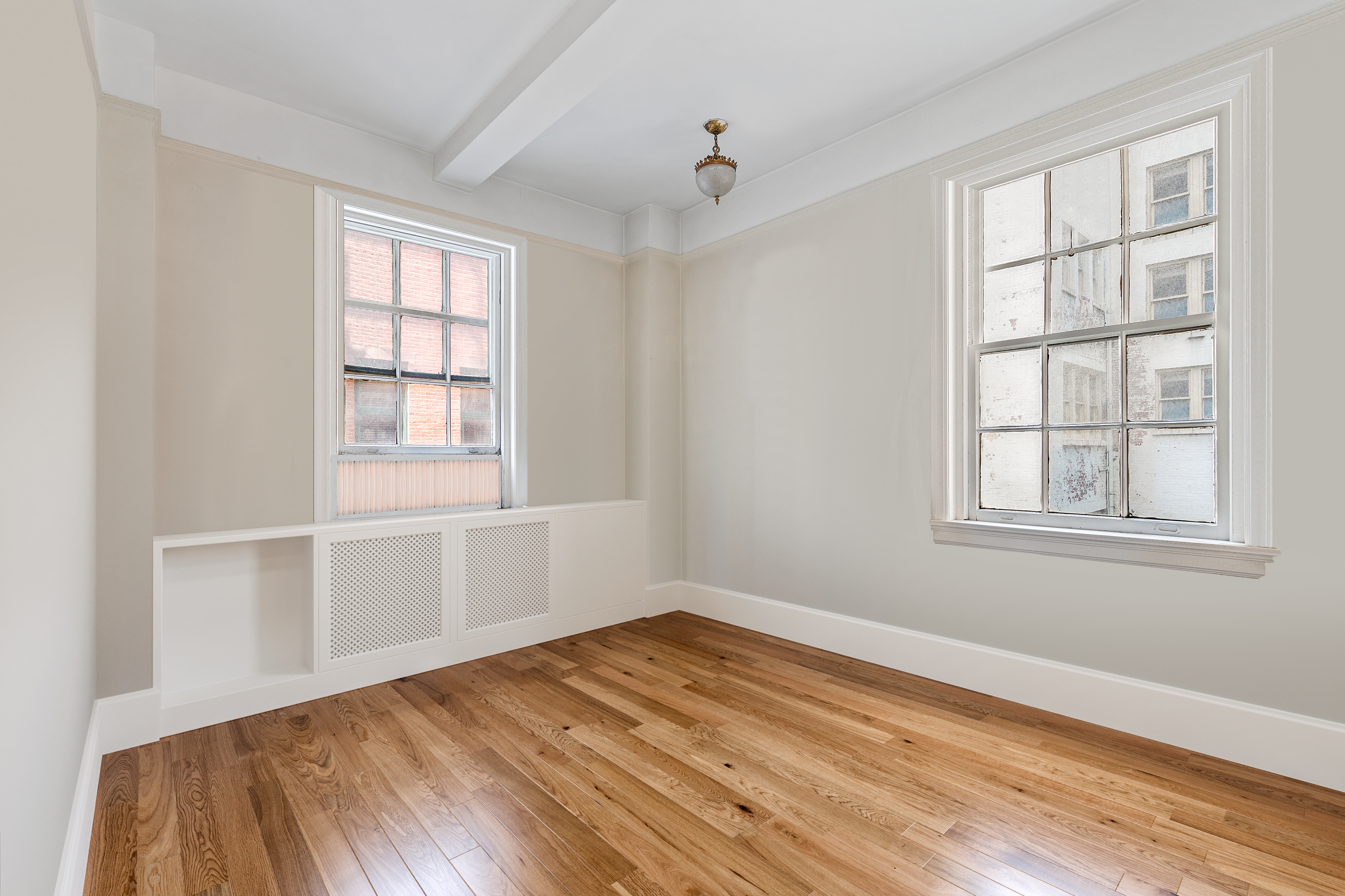 264 Lexington Avenue, Unit 4B Manhattan, NY 10016 - Photo 9 of 10 an empty room with wooden floor and windows