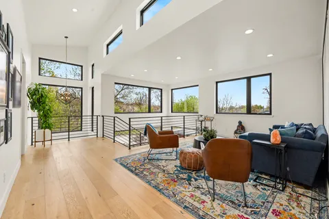 a living room with furniture and a wooden floor