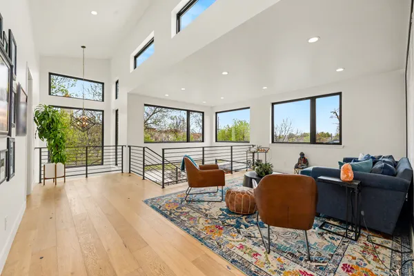 a living room with furniture and a wooden floor