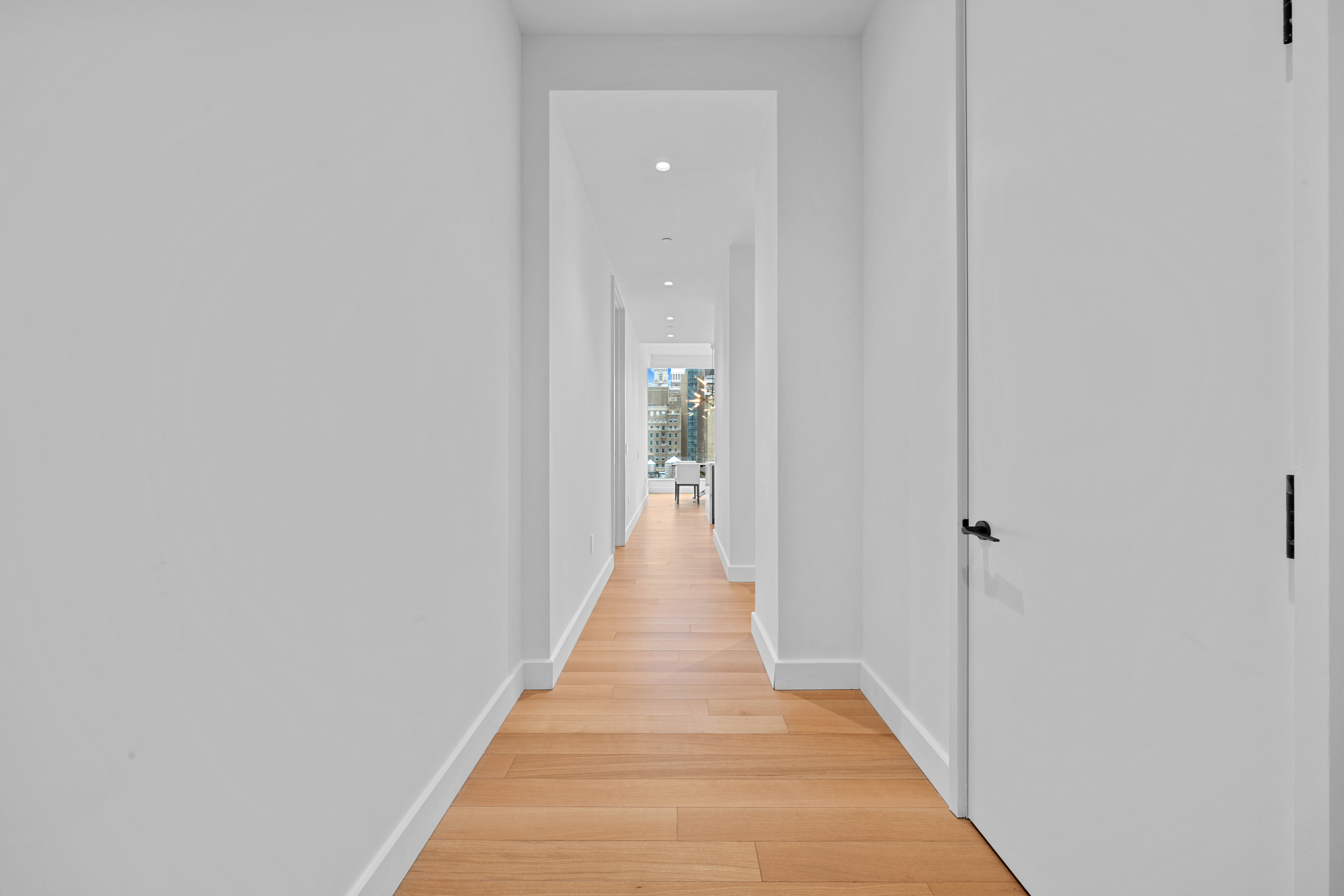 15 East 30th Street, Unit 19B Manhattan, NY 10016 - Photo 26 of 40 a view of a hallway with wooden floor and a bathroom