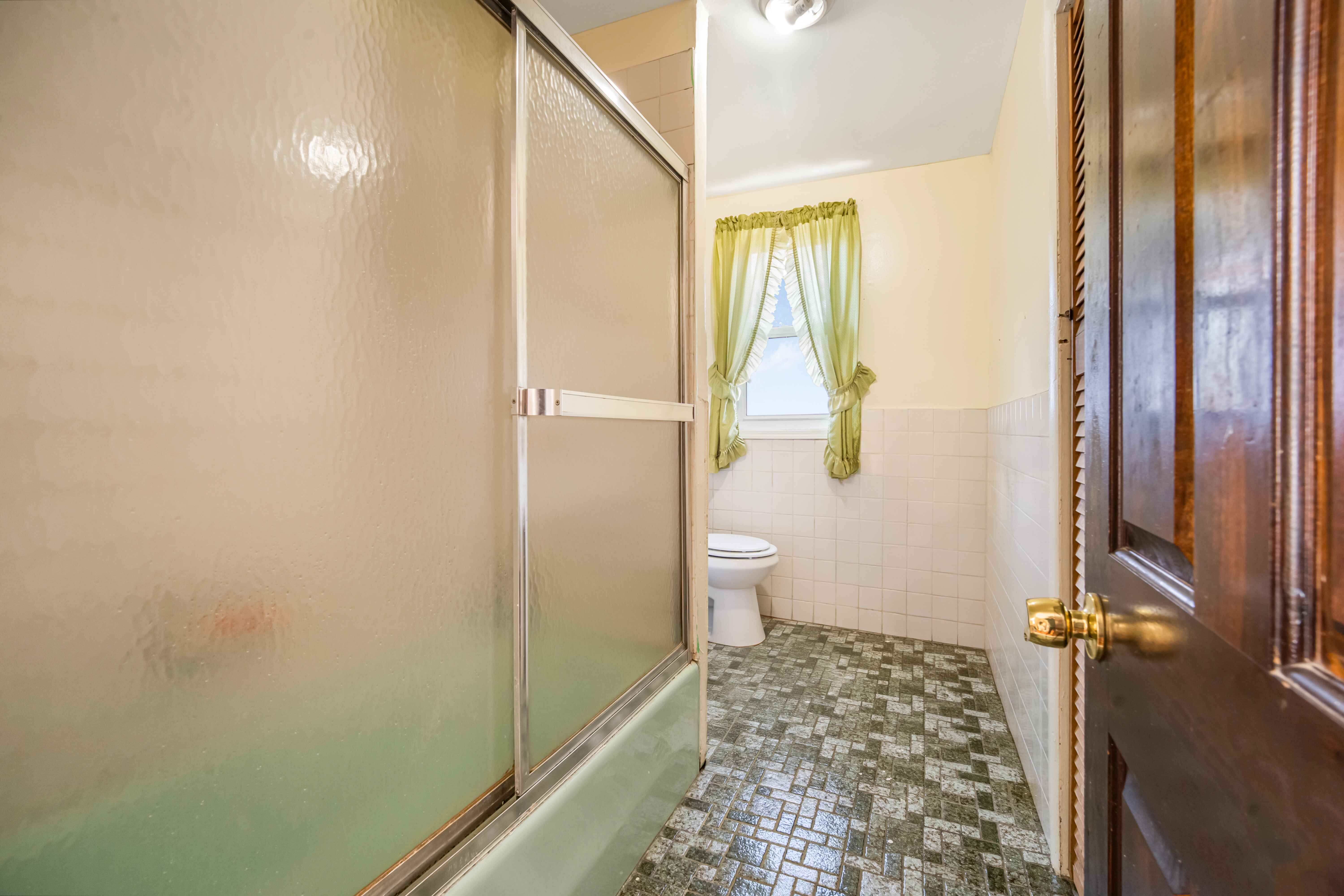 97-30 127th Street Queens, NY 11419 - Photo 13 of 27 a bathroom with a bathtub and a shower