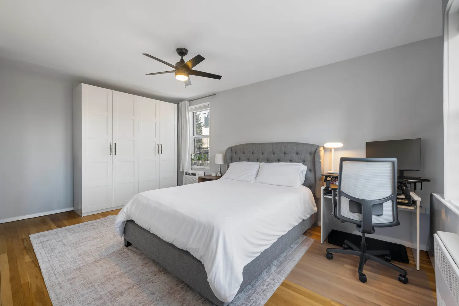 a bedroom with a bed lamp and a table