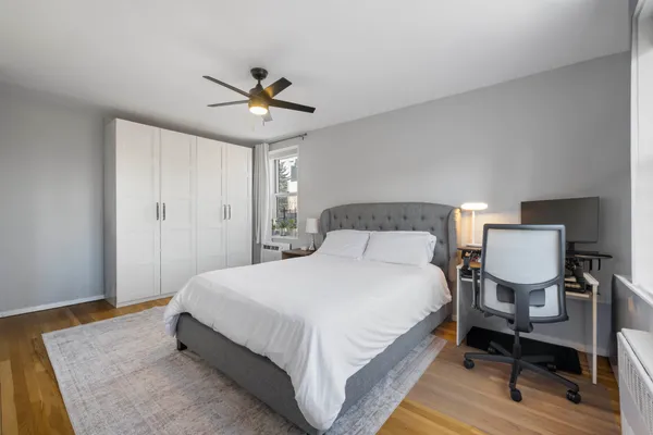 a bedroom with a bed lamp and a table