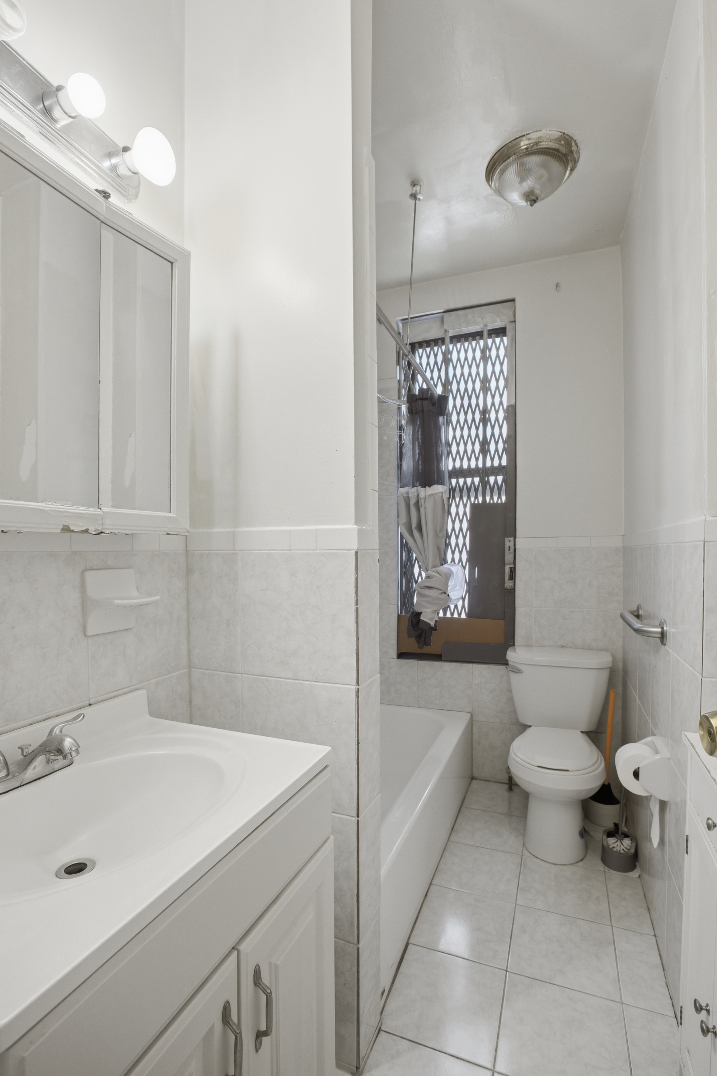 1809 Adam Clayton Powell Jr Boulevard, Unit 2D Manhattan, NY 10026 - Photo 7 of 15 a bathroom with a sink toilet and shower