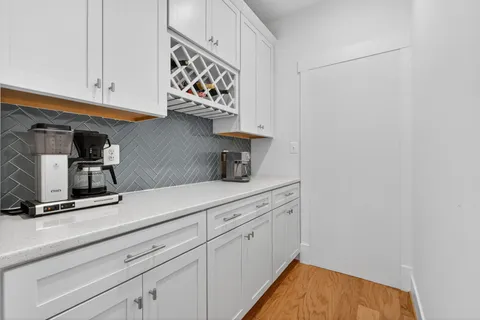 a kitchen with white cabinets and a sink