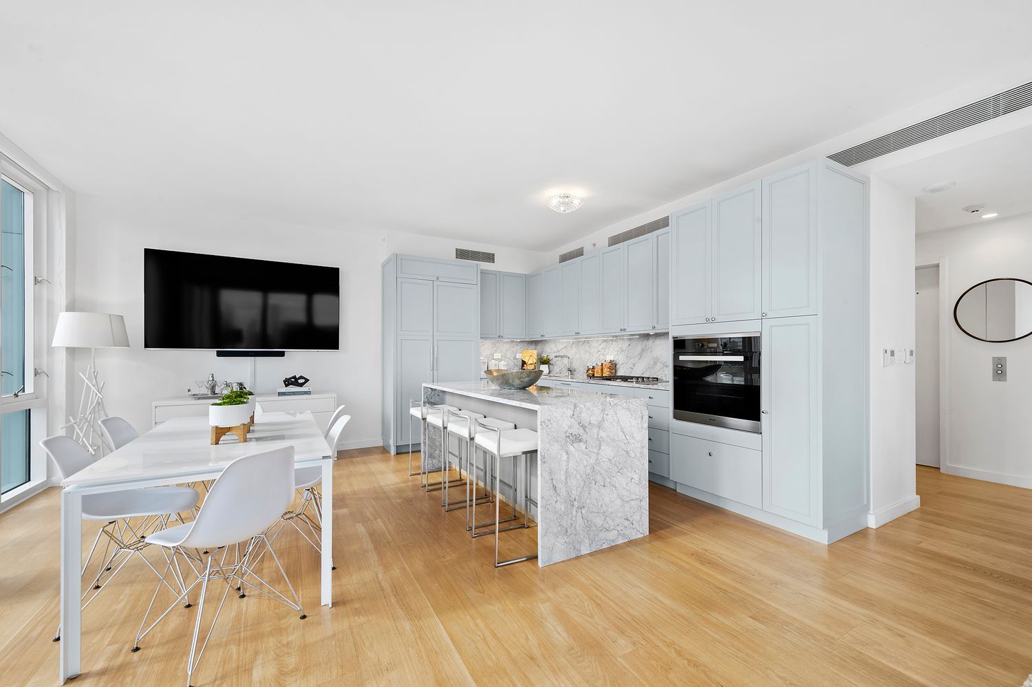 301 East 61st Street, Unit 16A Manhattan, NY 10065 - Photo 5 of 17 a living room with furniture wooden floor and flat screen tv