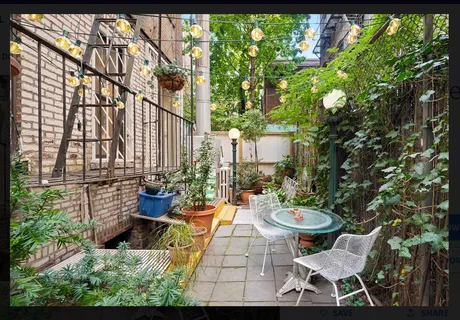 a view of a patio with table and chairs and potted plants
