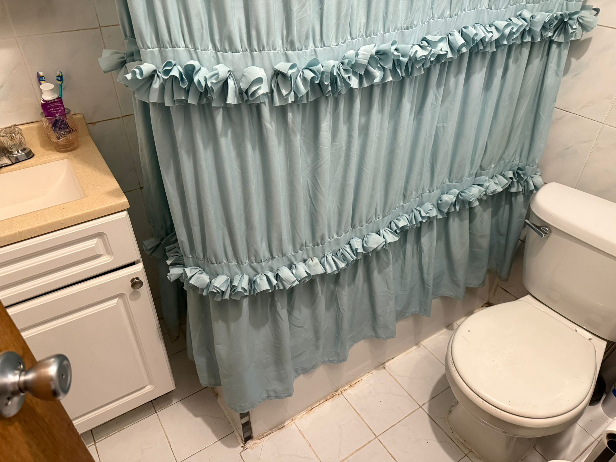 1278 1st Avenue, Unit 2 Manhattan, NY 10065 - Photo 18 of 19 a bathroom with a toilet and a shower curtain