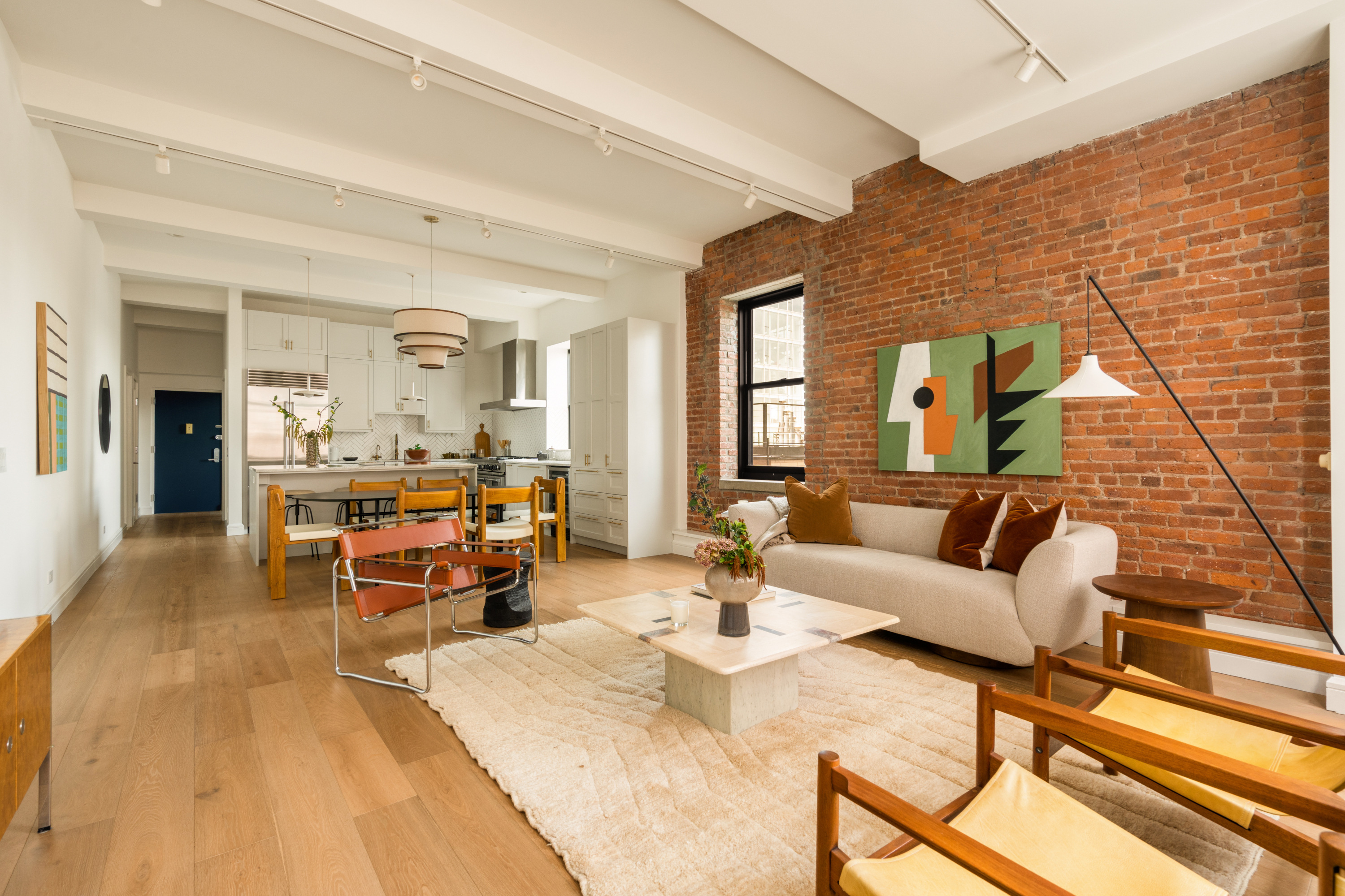 165 Perry Street, Unit 5A Manhattan, NY 10014 - Photo 2 of 14 a living room with furniture and wooden floor