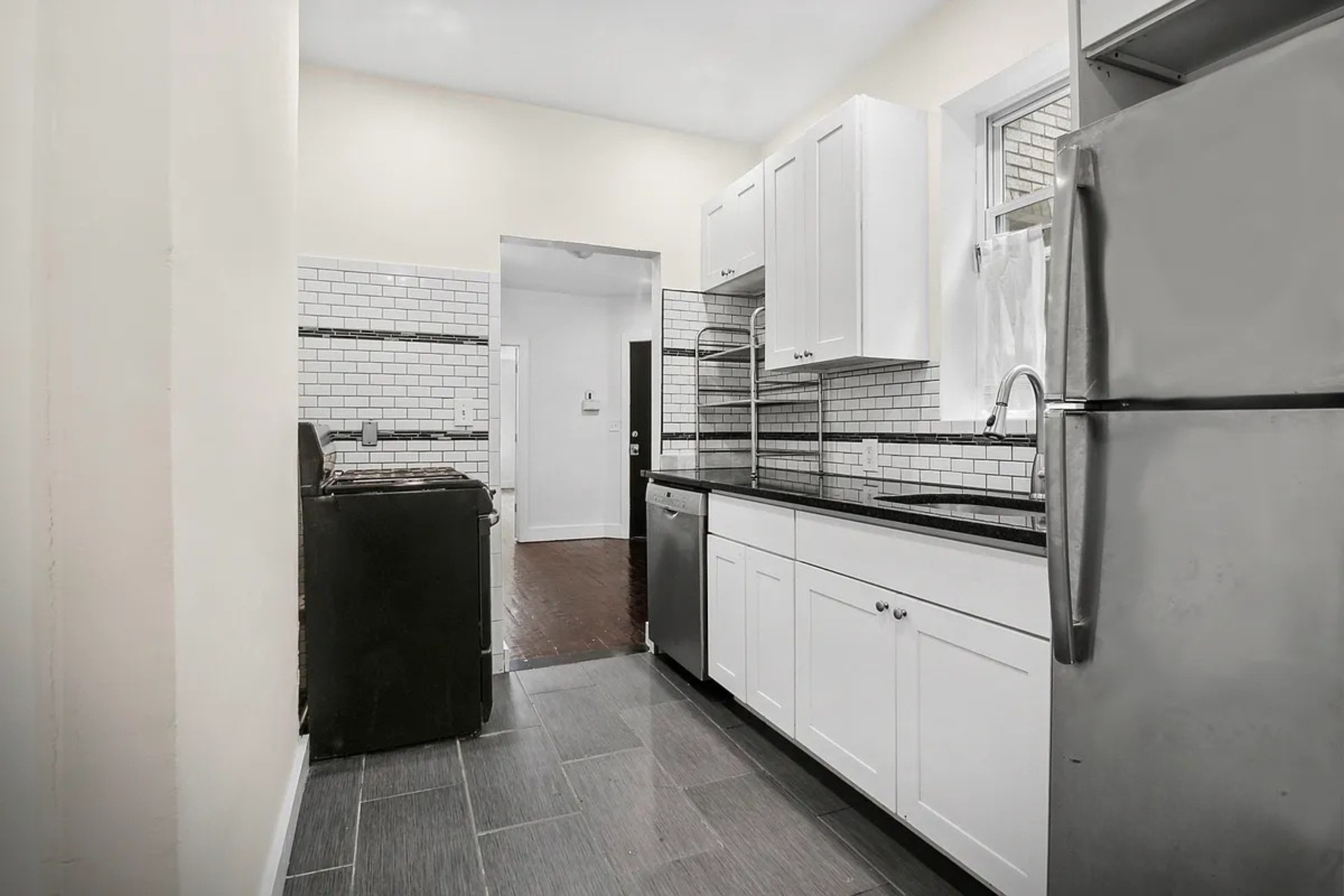 22-42 41st Street, Unit 2R Queens, NY 11105 - Photo 3 of 10 a kitchen with a refrigerator and a stove