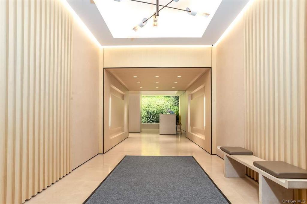 785 5th Avenue, Unit 3C Manhattan, NY 10022 - Photo 12 of 16 a view of a hallway with windows