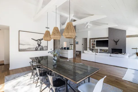 a dining room with wooden floor and breakfast area