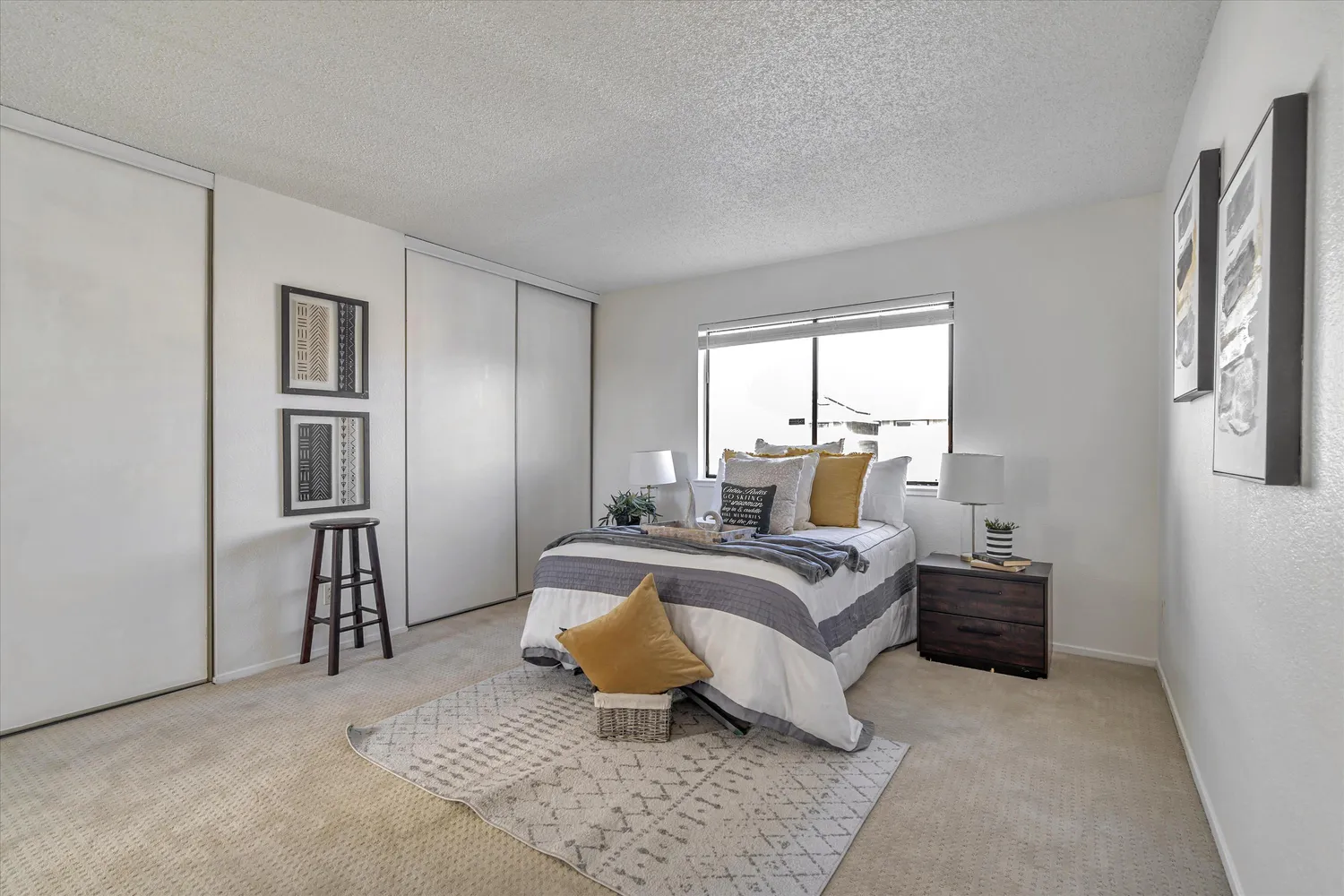 a living room with a bed furniture and a window