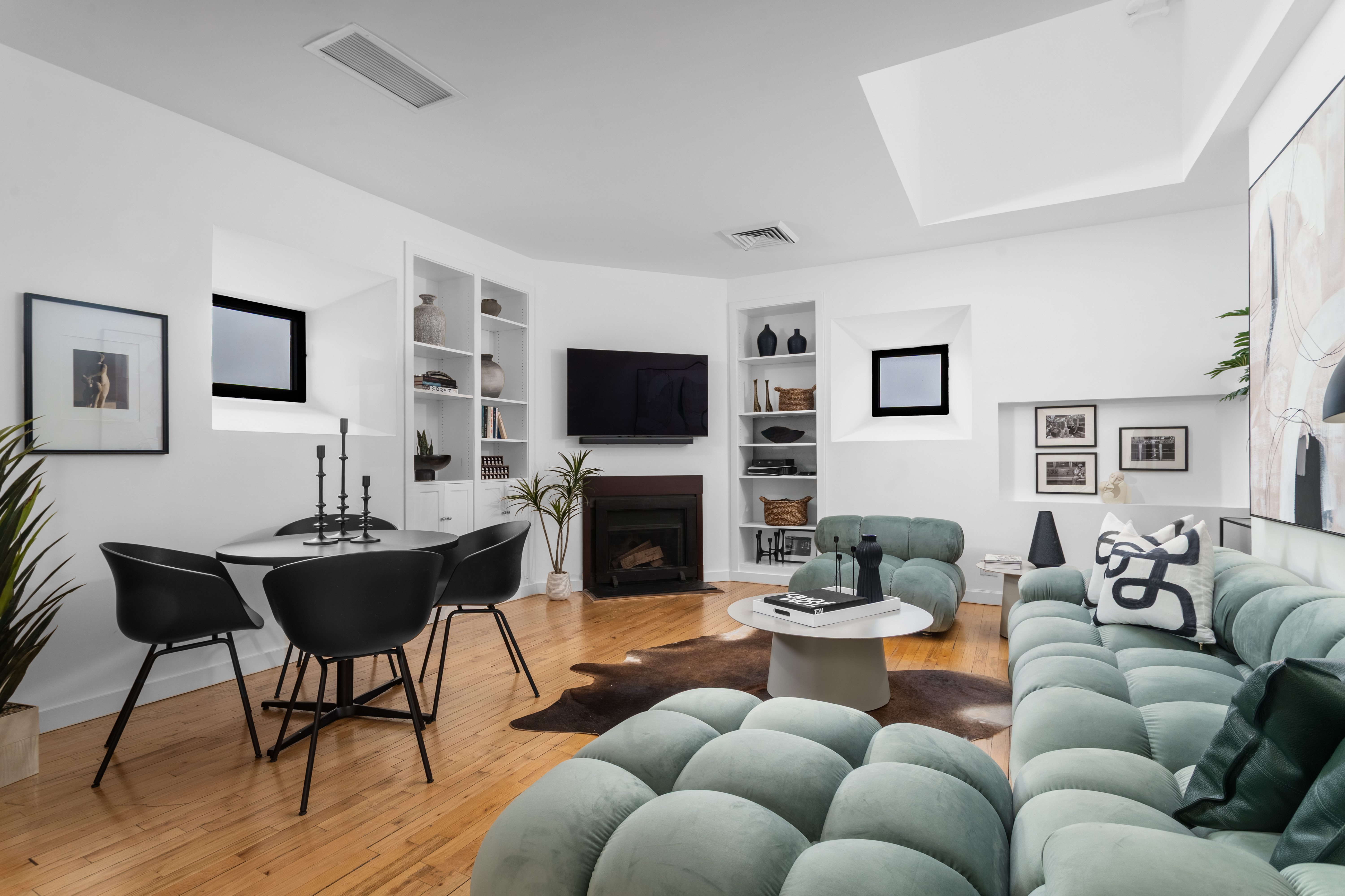 a living room with furniture a fireplace and a flat screen tv