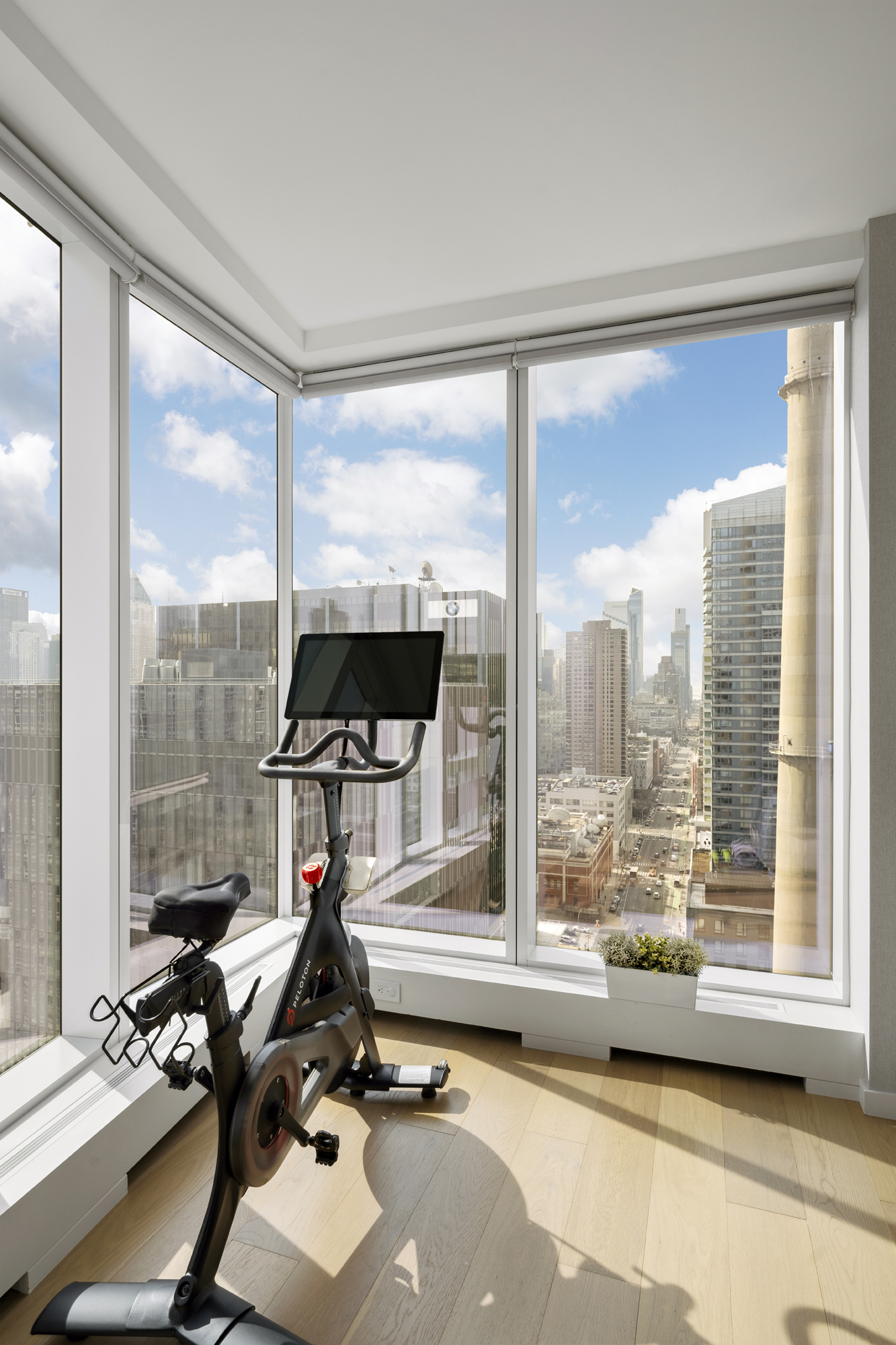 1 West End Avenue, Unit 22C Manhattan, NY 10023 - Photo 9 of 15 a view of a room with gym equipment and floor to ceiling window