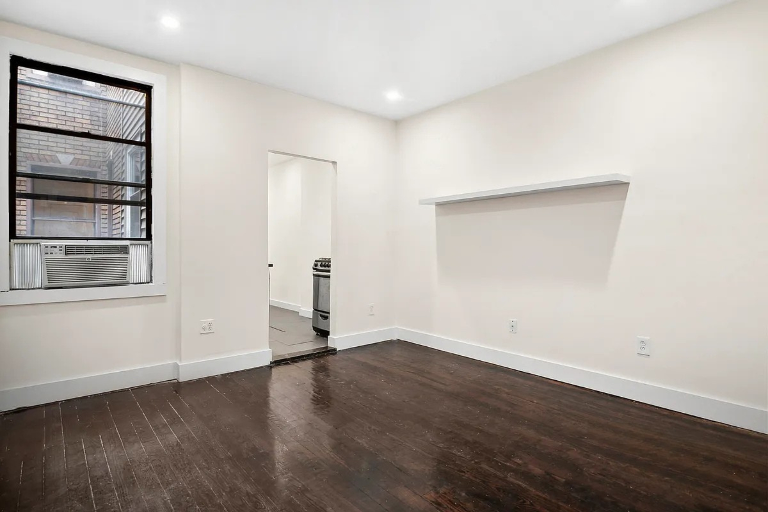 22-42 41st Street, Unit 2R Queens, NY 11105 - Photo 2 of 10 an empty room with wooden floor and closet