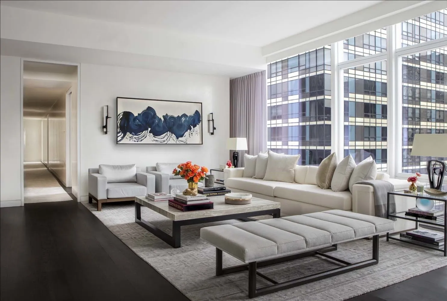 a living room with furniture a rug and a large window