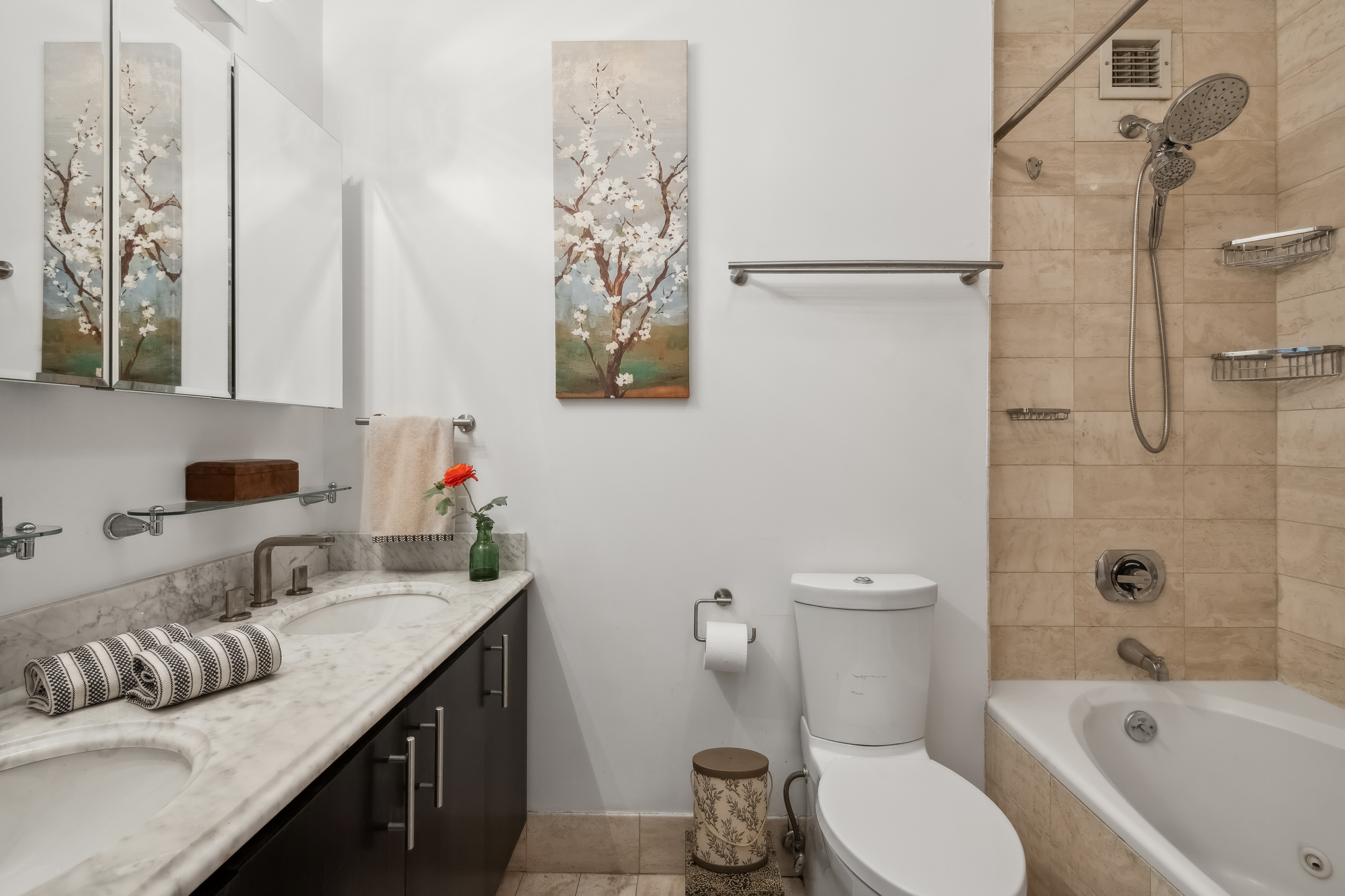 200 East 61st Street, Unit 18A Manhattan, NY 10065 - Photo 6 of 9 a bathroom with a granite countertop sink a toilet and shower
