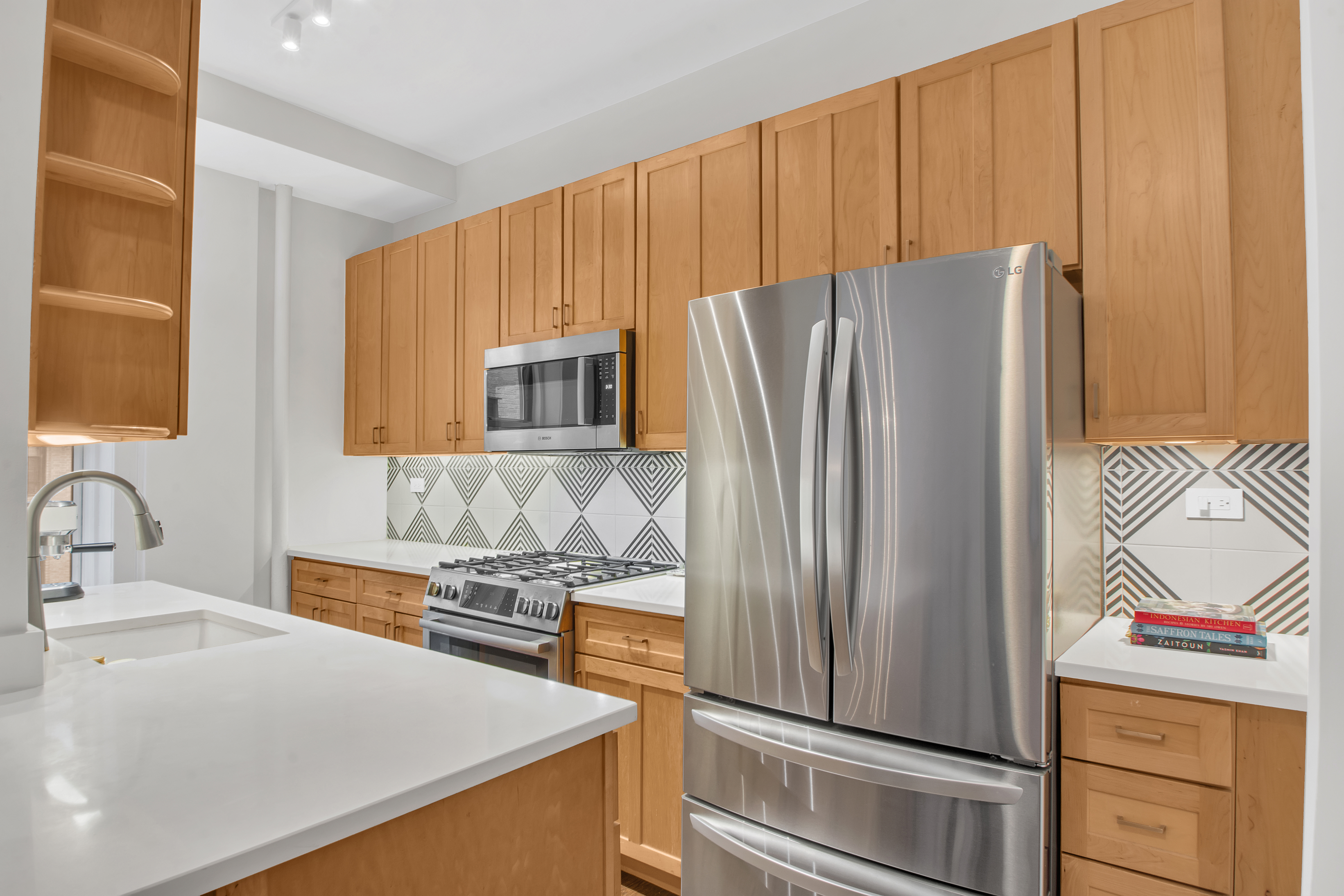 800 Riverside Drive, Unit 2E Manhattan, NY 10032 - Photo 8 of 27 a kitchen with granite countertop a refrigerator and a sink