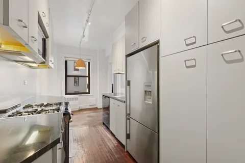 a kitchen with stainless steel appliances granite countertop a refrigerator and a stove