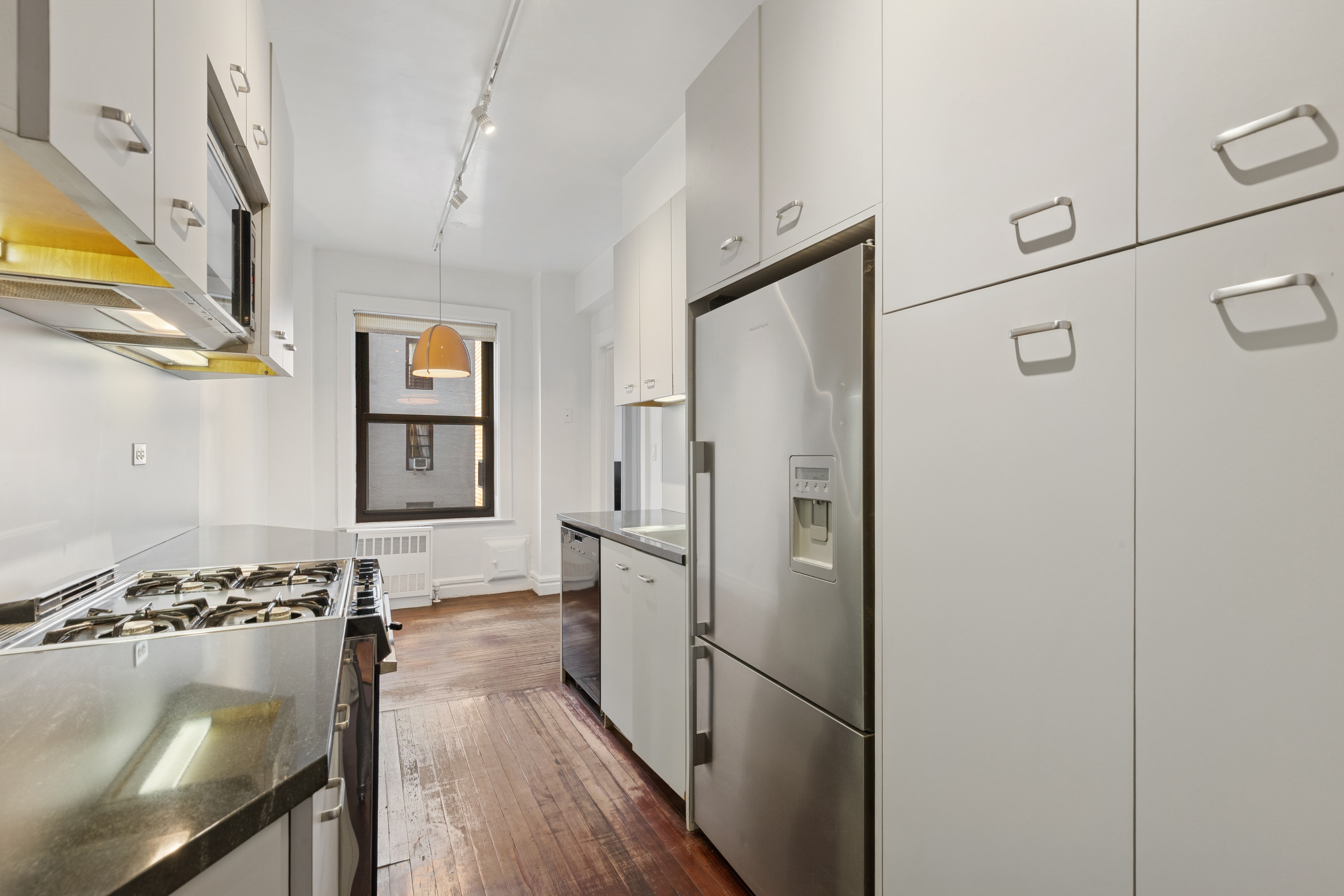 710 West End Avenue, Unit 14B Manhattan, NY 10025 - Photo 7 of 19 a kitchen with stainless steel appliances granite countertop a refrigerator and a stove