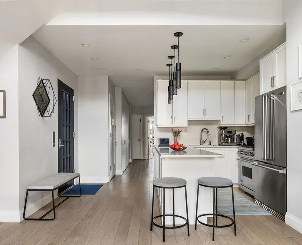 a kitchen with stainless steel appliances a refrigerator and a stove top oven