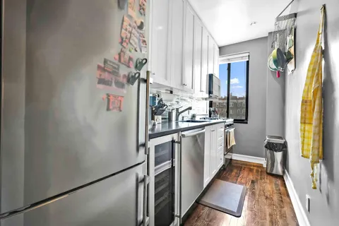 a kitchen with stainless steel appliances a refrigerator and a stove