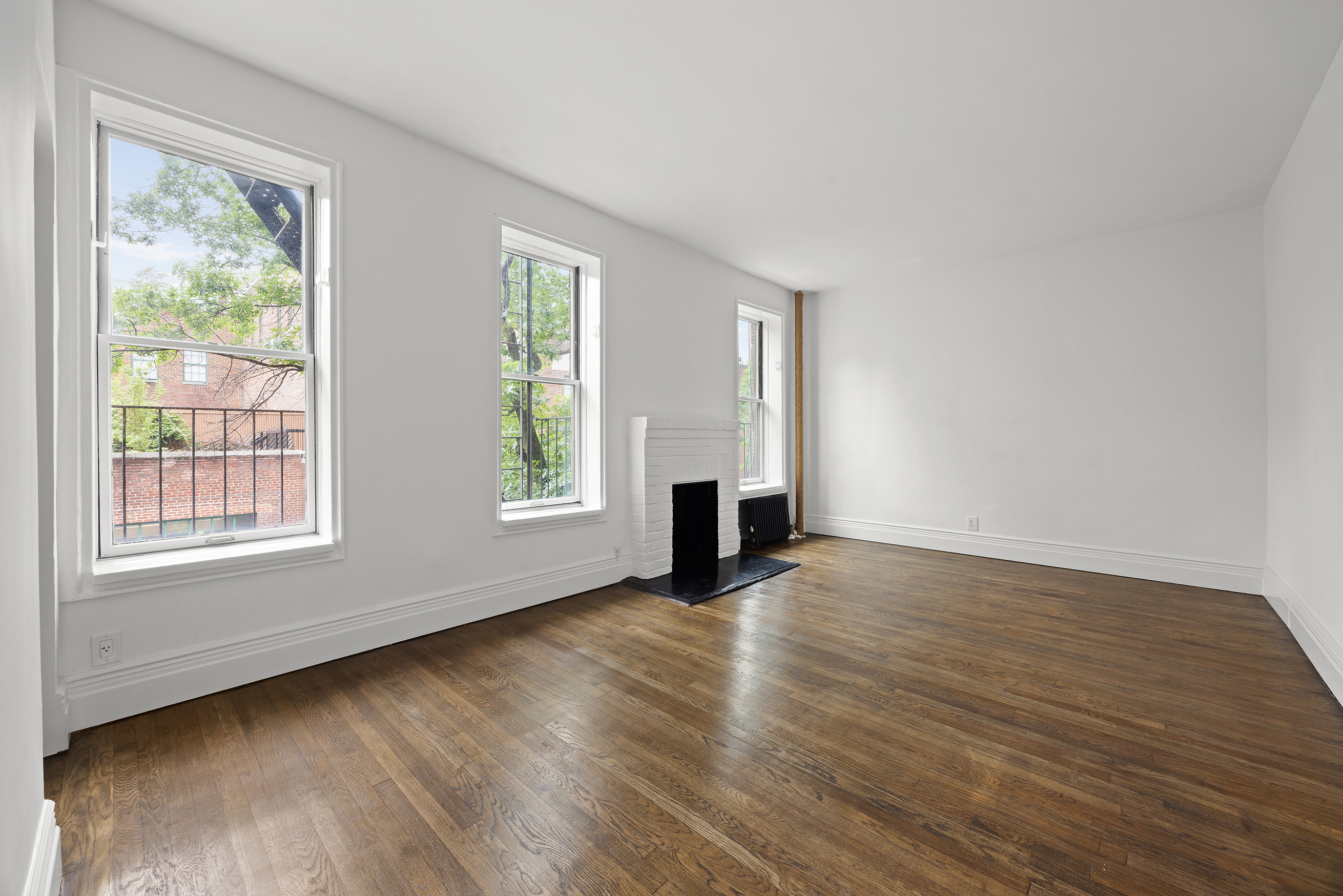 10 Bethune Street, Unit 2B Manhattan, NY 10014 - Photo 2 of 7 a view of an empty room with wooden floor and a window