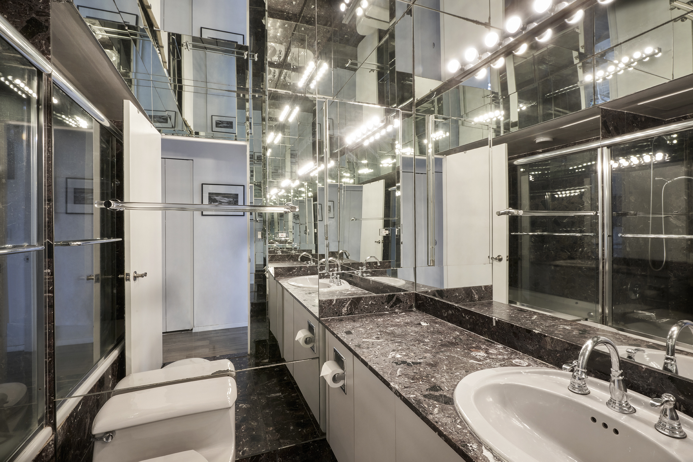 304 East 65th Street, Unit 12D Manhattan, NY 10065 - Photo 3 of 6 a bathroom with double vanity and a shower