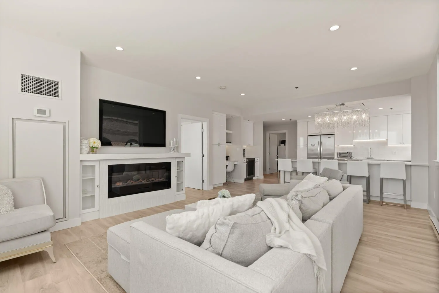 a living room with furniture a fireplace and a flat screen tv