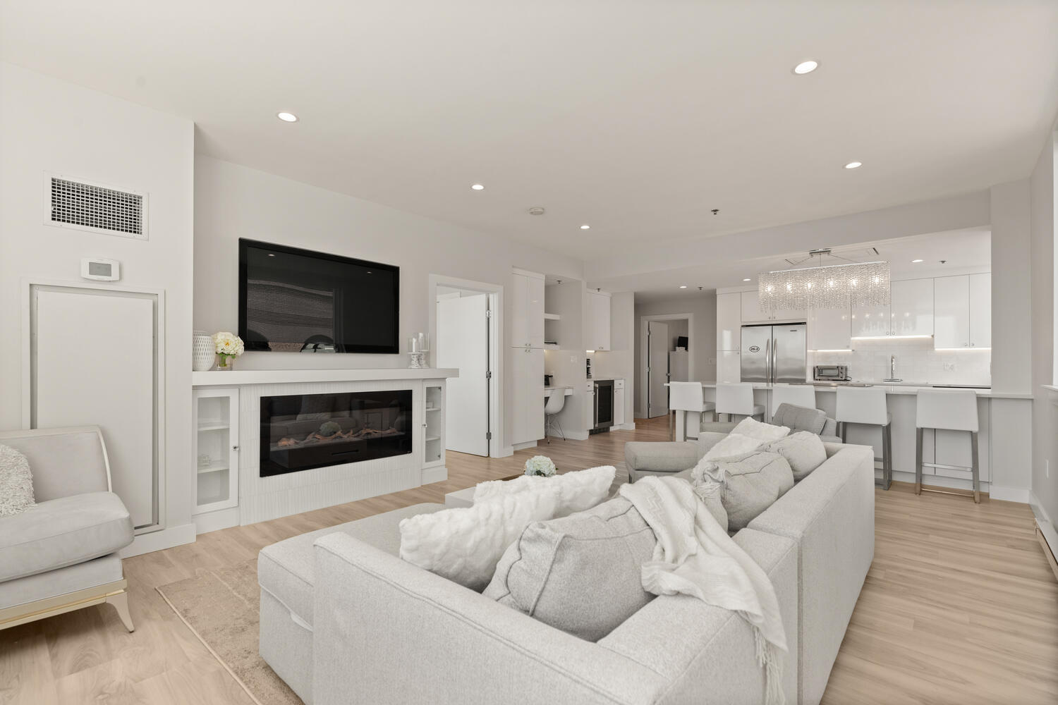 a living room with furniture a fireplace and a flat screen tv