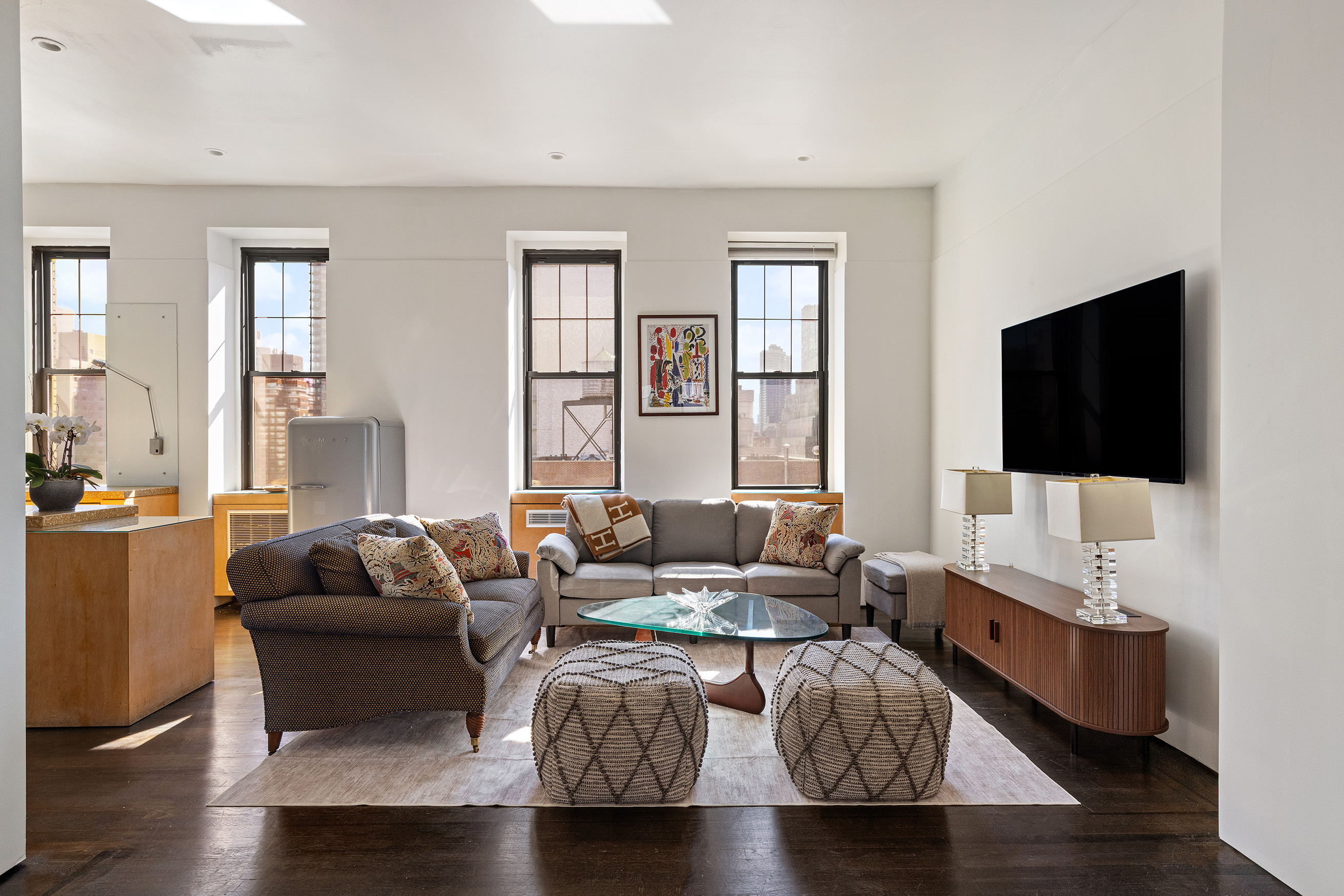 521 Park Avenue, Unit 10A Manhattan, NY 10065 - Photo 2 of 11 a living room with furniture and a flat screen tv