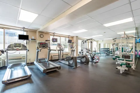 a view of a patio with a table and chairs under an umbrella