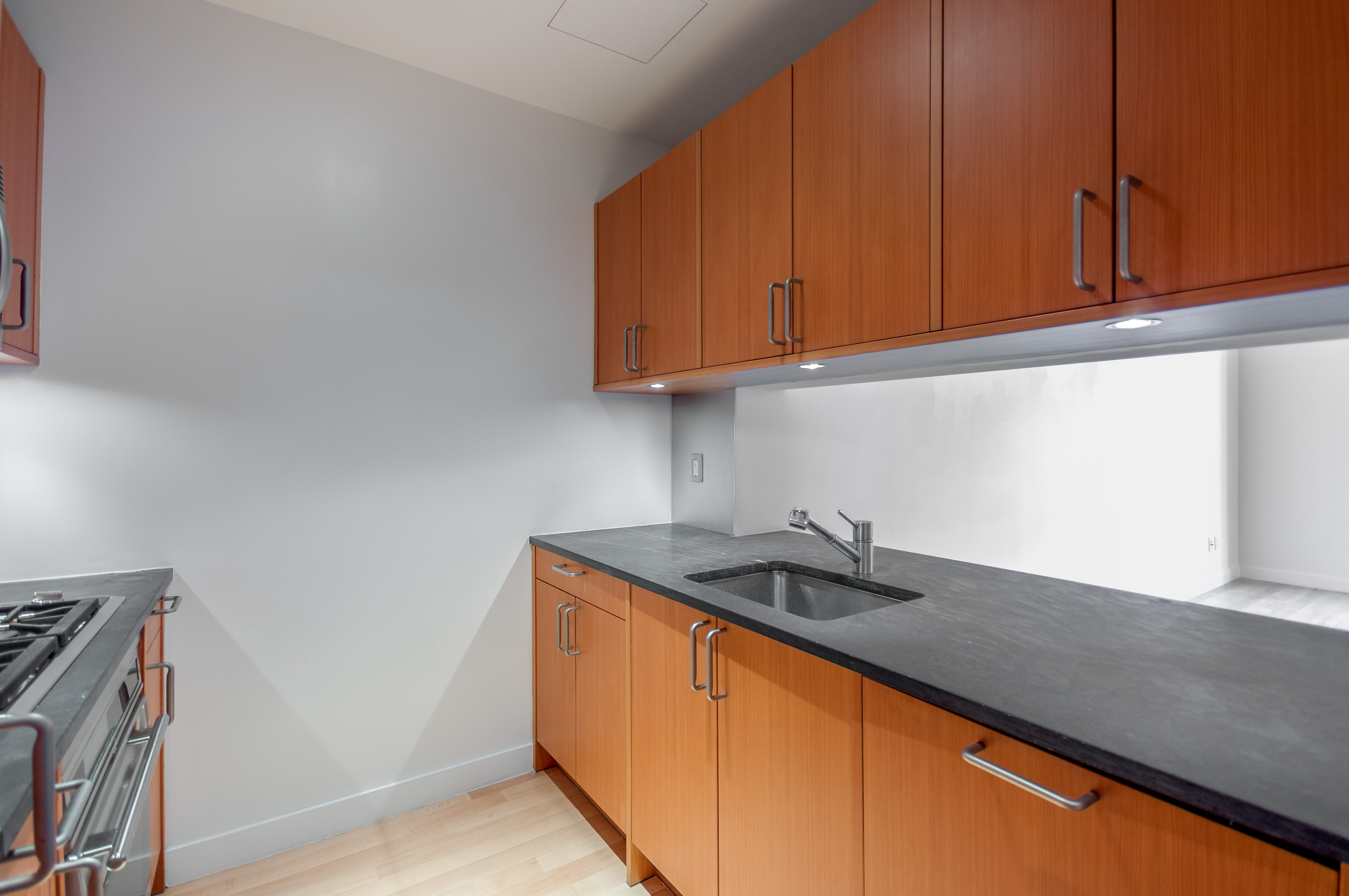 450 East 83rd Street, Unit 3D Manhattan, NY 10028 - Photo 8 of 15 a kitchen with granite countertop cabinets and a sink