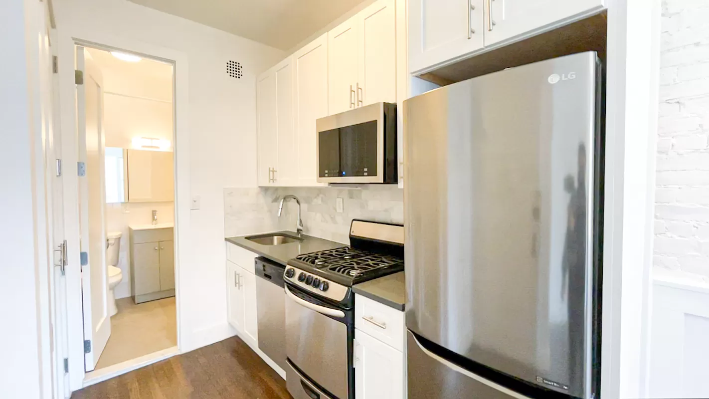 1736 2nd Avenue, Unit 4A Manhattan, NY 10128 - Photo 2 of 6 a kitchen with stainless steel appliances a refrigerator and a stove
