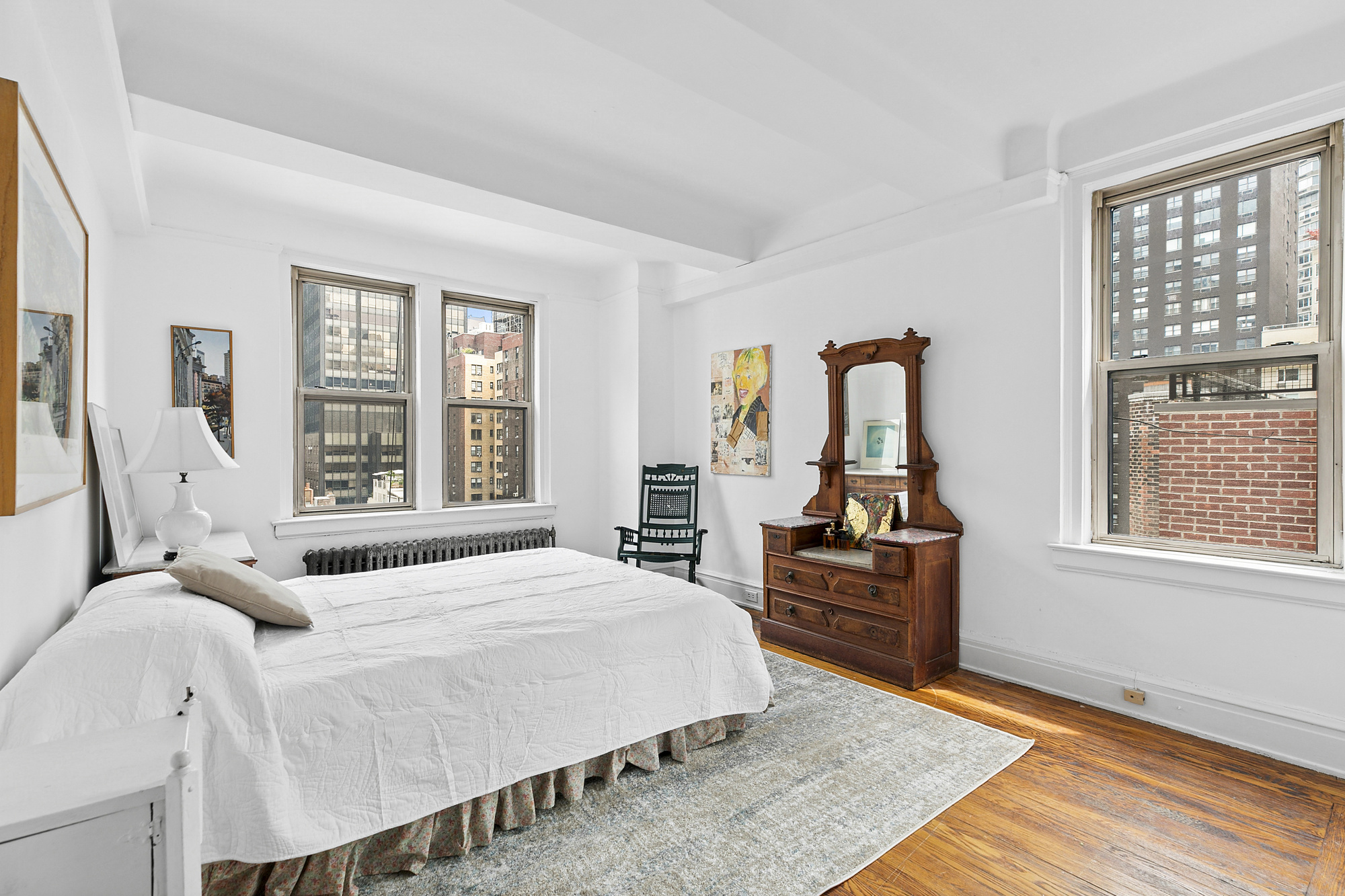 333 East 53rd Street, Unit 12L Manhattan, NY 10022 - Photo 5 of 9 a bedroom with a bed and wooden floor