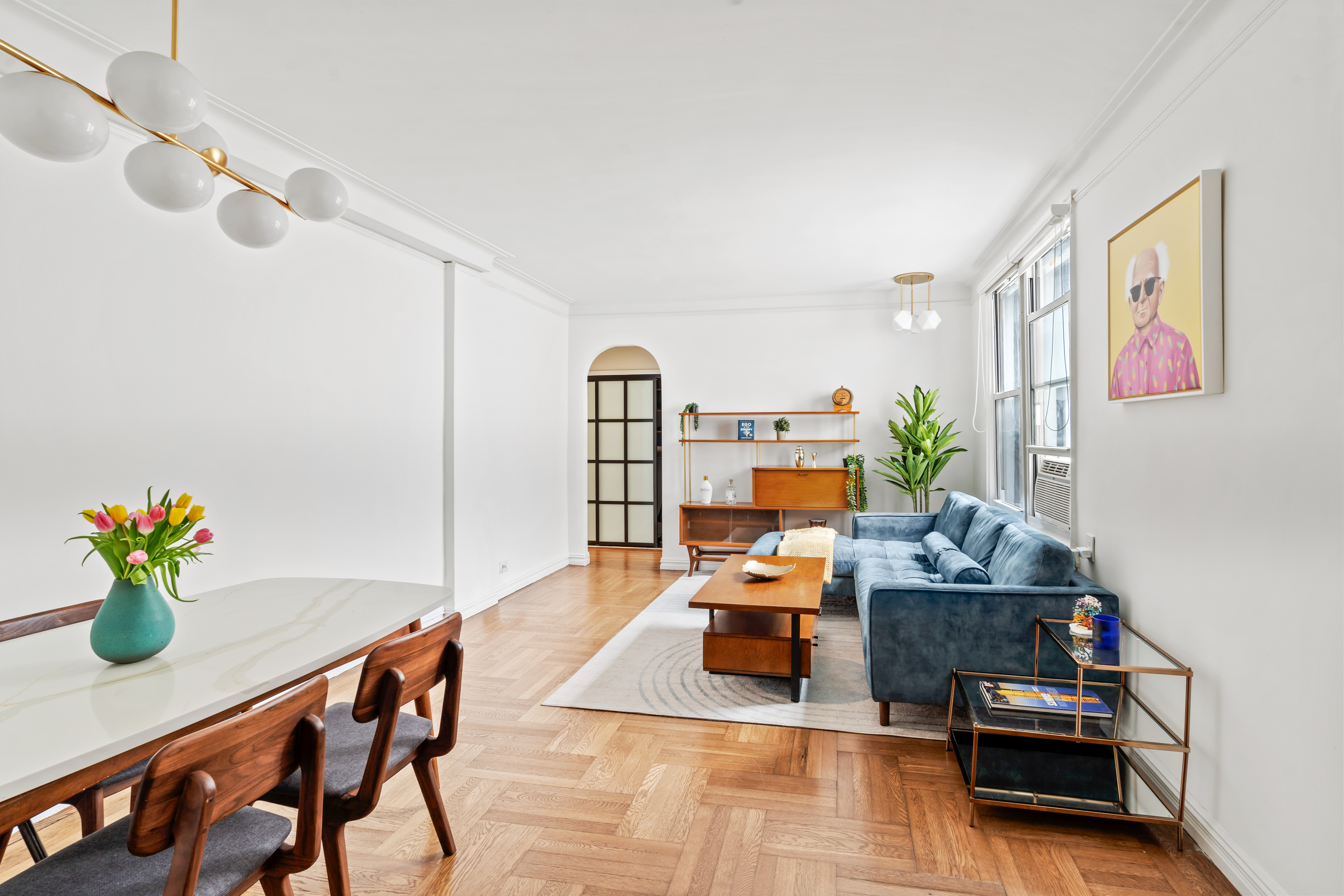 225 West 25th Street, Unit 5D Manhattan, NY 10001 - Photo 2 of 16 a living room with furniture and flowers