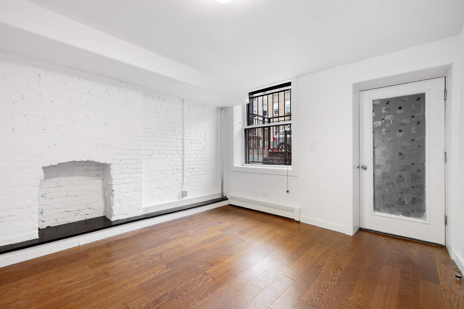 63 Putnam Avenue Brooklyn, NY 11238 - Photo 10 of 11 an empty room with wooden floor and windows
