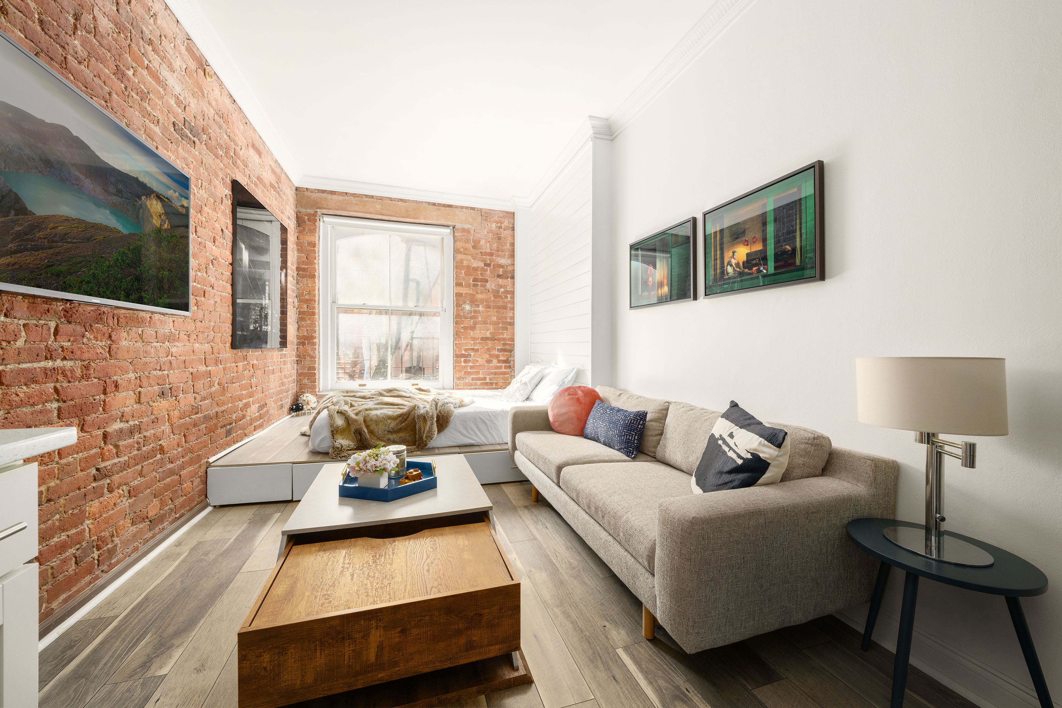 77 Perry Street, Unit 1A Manhattan, NY 10014 - Photo 2 of 6 a living room with furniture and a flat screen tv