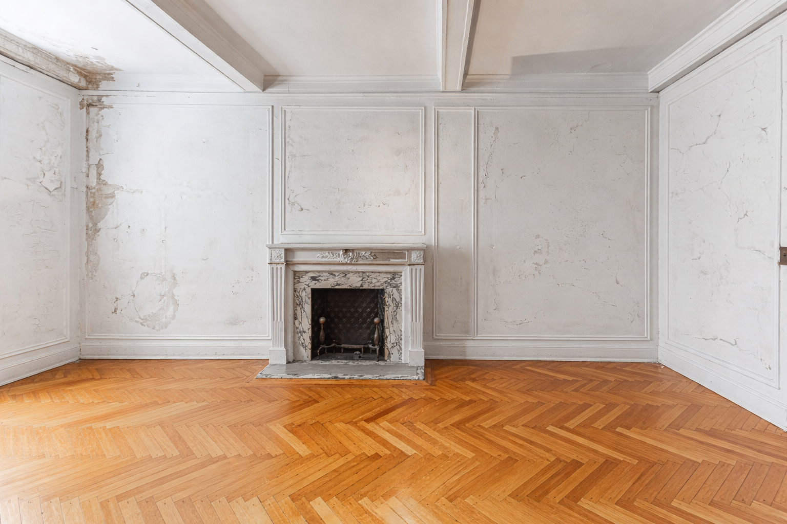 a view of empty room with a fireplace and wooden floor